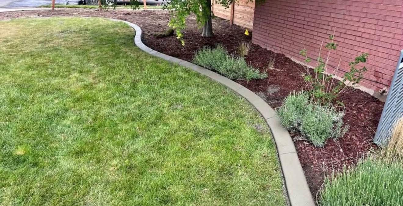 Finished Summit Landscape & Excavation project in Utah County with fresh sod, concrete curbing, and mulched beds